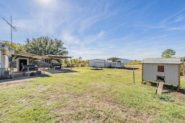 view of yard featuring a storage unit and a carport