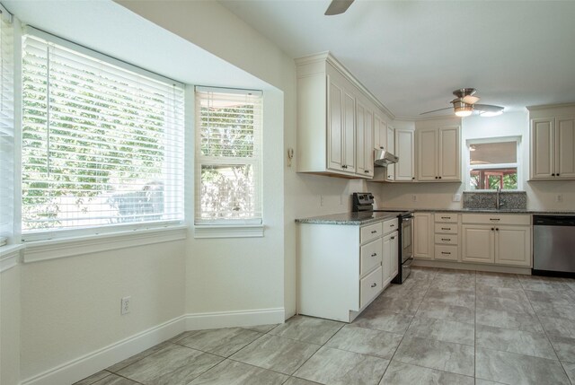 kitchen with electric range, stainless steel dishwasher, and a wealth of natural light