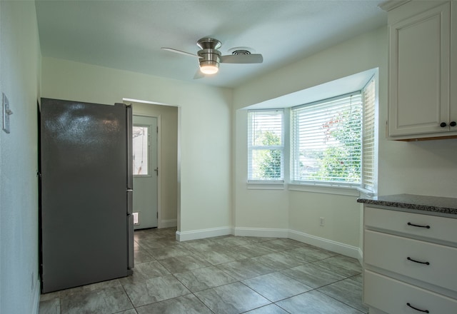 interior space with ceiling fan and light tile patterned floors