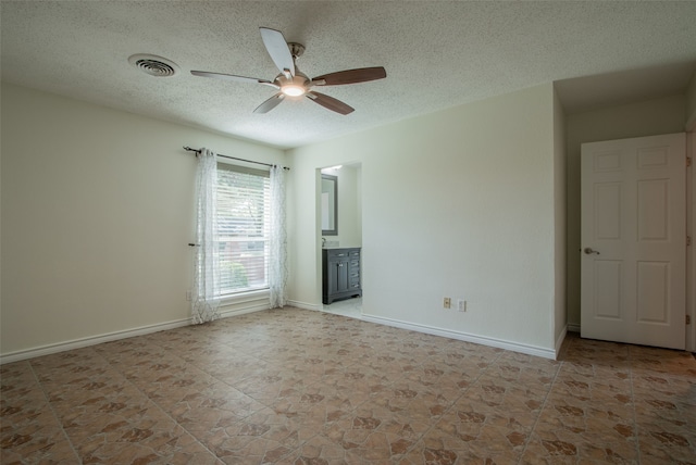 spare room featuring ceiling fan and a textured ceiling