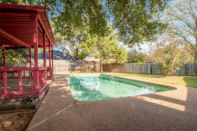 view of swimming pool featuring a patio and a deck