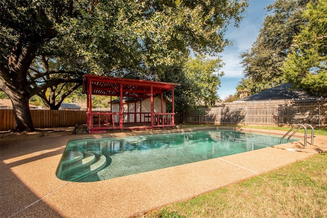 view of swimming pool with a pergola and a wooden deck