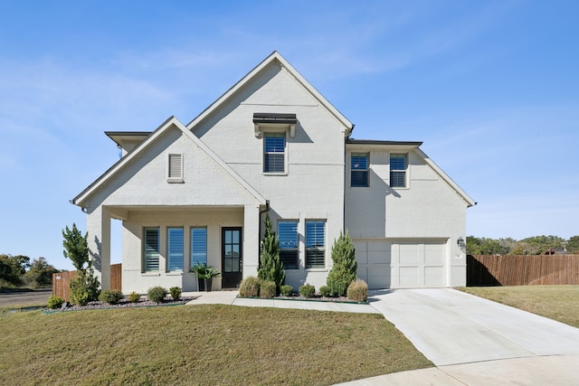 view of front of home with a garage and a front lawn