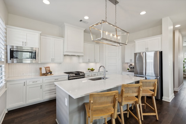 kitchen featuring dark hardwood / wood-style flooring, sink, white cabinets, and appliances with stainless steel finishes