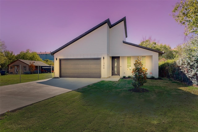 view of front of property with a yard and a garage