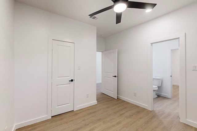 unfurnished bedroom with light wood-type flooring, ensuite bathroom, and ceiling fan