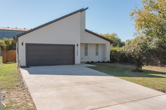 view of front of property with a garage and a front yard