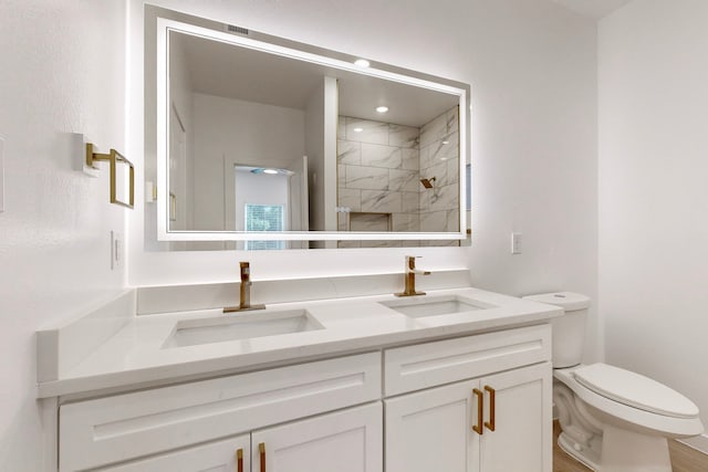 bathroom with hardwood / wood-style flooring, toilet, vanity, and tiled shower