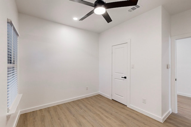 spare room featuring ceiling fan and light wood-type flooring