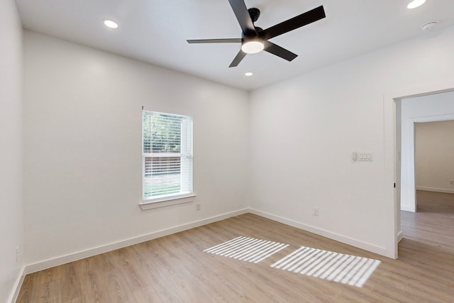 empty room featuring ceiling fan and light hardwood / wood-style floors