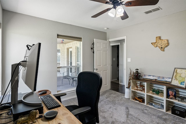 carpeted office featuring ceiling fan