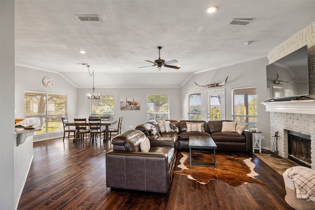 living room with crown molding, dark wood-type flooring, vaulted ceiling, and a brick fireplace