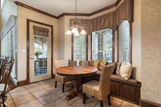 tiled dining area with crown molding and a chandelier