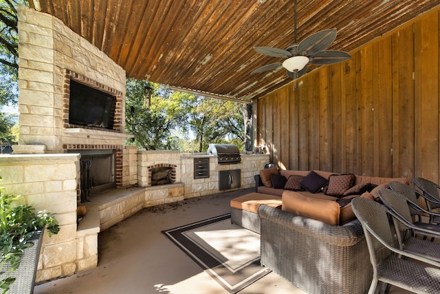 view of patio featuring an outdoor living space with a fireplace, an outdoor kitchen, a grill, and ceiling fan