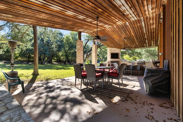 view of patio / terrace with ceiling fan and an outdoor stone fireplace