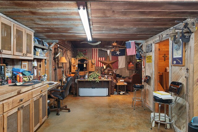 basement with a workshop area and wooden walls