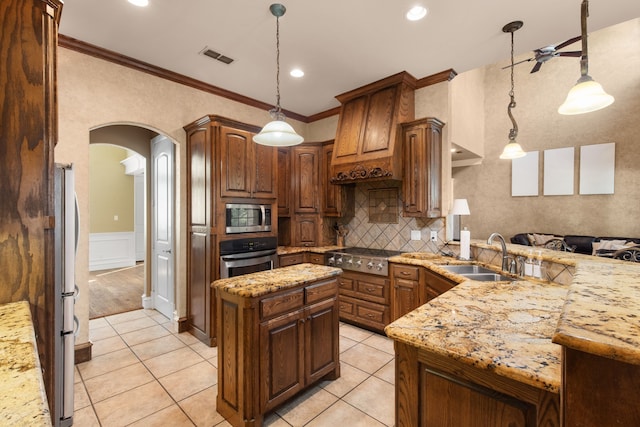 kitchen featuring pendant lighting, a center island, stainless steel appliances, and sink