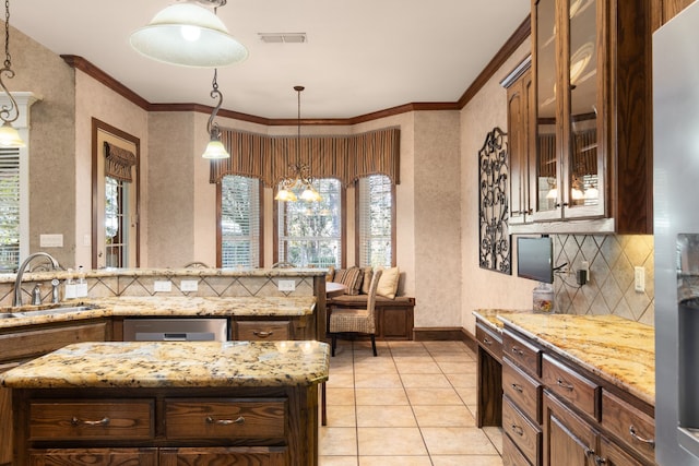 kitchen with a chandelier, decorative light fixtures, stainless steel dishwasher, and sink