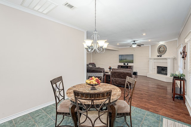 dining room featuring ceiling fan with notable chandelier, dark hardwood / wood-style floors, and ornamental molding