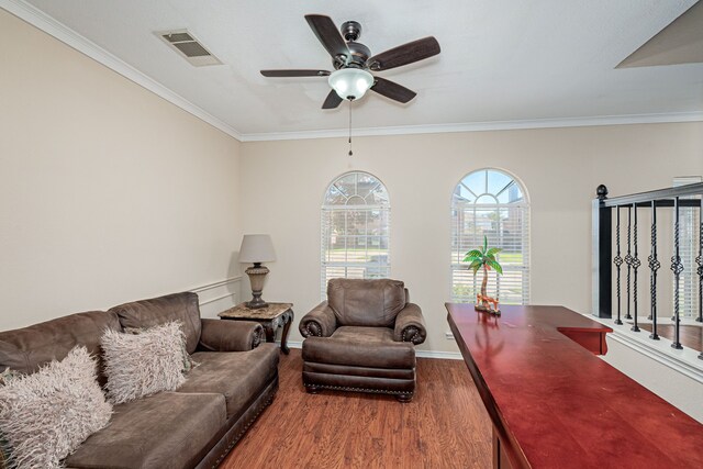 living room with hardwood / wood-style floors, ceiling fan, and crown molding