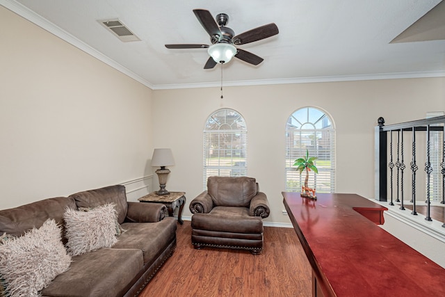 living room with hardwood / wood-style floors, ornamental molding, and ceiling fan