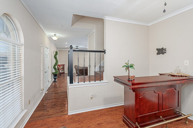 hallway with dark hardwood / wood-style floors and ornamental molding