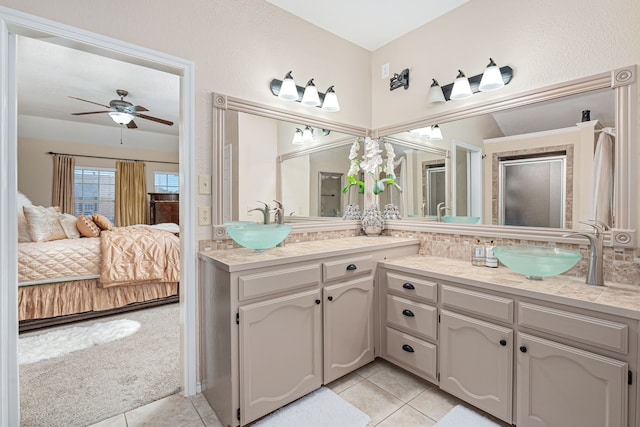 bathroom featuring tile patterned flooring, vanity, and ceiling fan