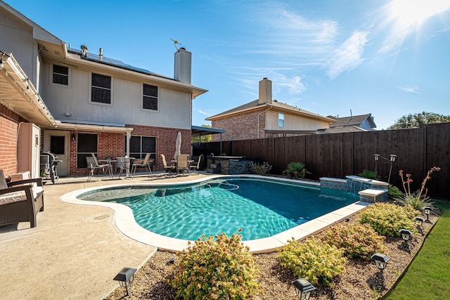 view of pool with a jacuzzi and a patio