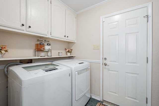 laundry area with cabinets, separate washer and dryer, and crown molding