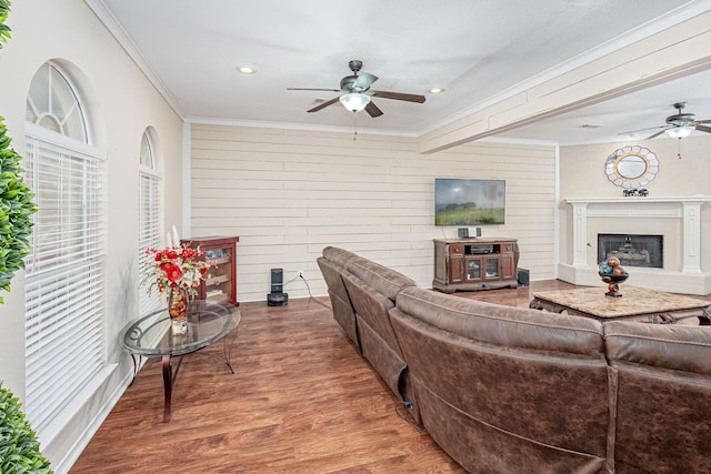 living room with wood-type flooring, ceiling fan, and ornamental molding