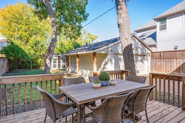 wooden terrace with a yard, an outbuilding, and a garage