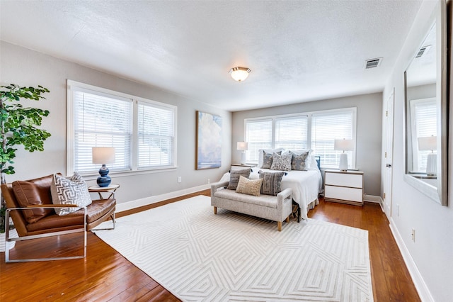 bedroom featuring a textured ceiling and hardwood / wood-style flooring