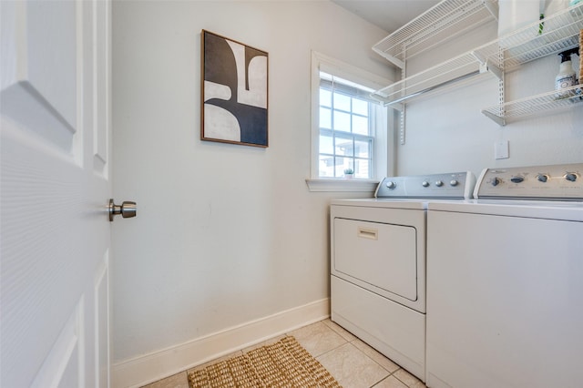 washroom featuring washing machine and clothes dryer and light tile patterned flooring