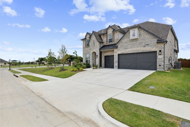 french country inspired facade featuring cooling unit, a garage, and a front yard