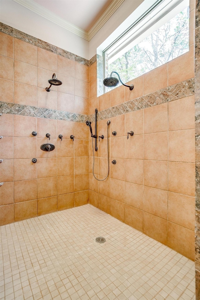 bathroom with a tile shower and crown molding