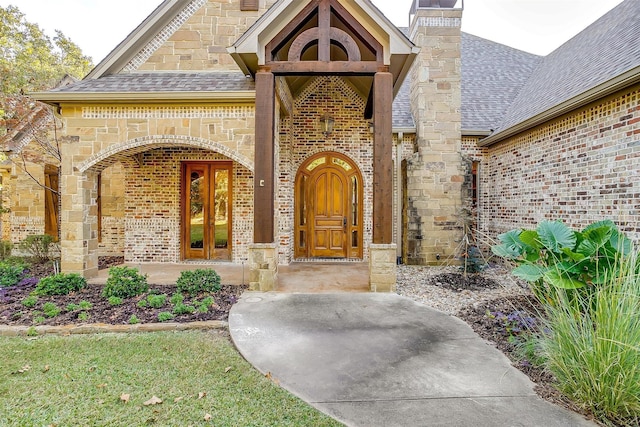 143 Coldwater Creek Ln, Weatherford, TX 76088 - property entrance with a shingled roof, brick siding, a chimney, and stone siding