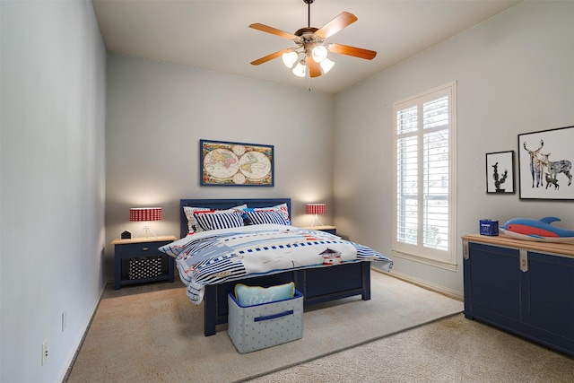 bedroom with ceiling fan and light carpet