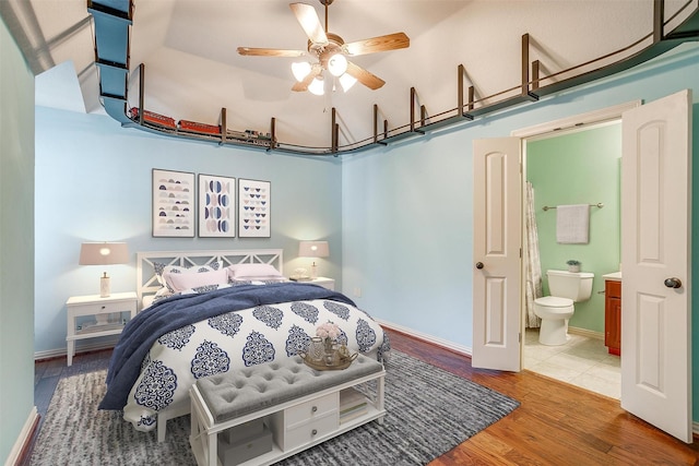 143 Coldwater Creek Ln, Weatherford, TX 76088 - bedroom featuring wood finished floors, connected bathroom, baseboards, and a towering ceiling