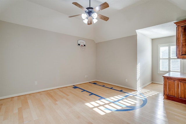 spare room featuring ceiling fan, light hardwood / wood-style flooring, and lofted ceiling