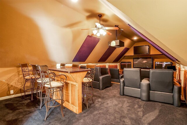 carpeted cinema room with lofted ceiling