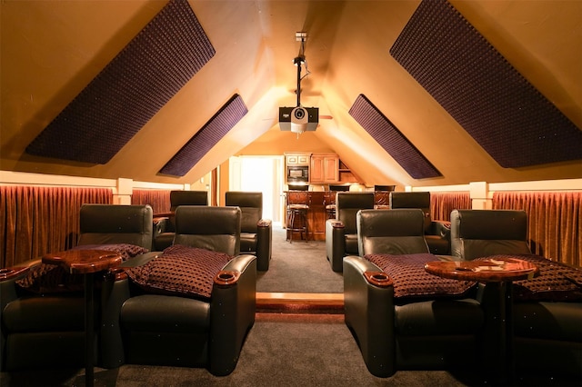 carpeted cinema room featuring lofted ceiling