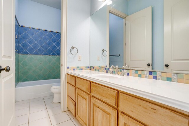 full bathroom featuring toilet, vanity, tile patterned floors, and tiled shower / bath combo