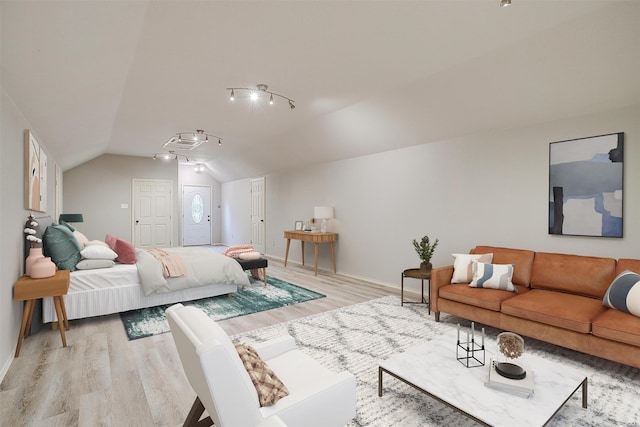 living room featuring light hardwood / wood-style flooring and vaulted ceiling