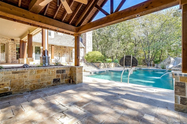 view of swimming pool featuring a patio area, ceiling fan, and pool water feature