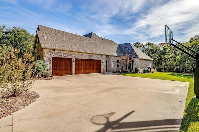 view of front of home with a front yard and a garage