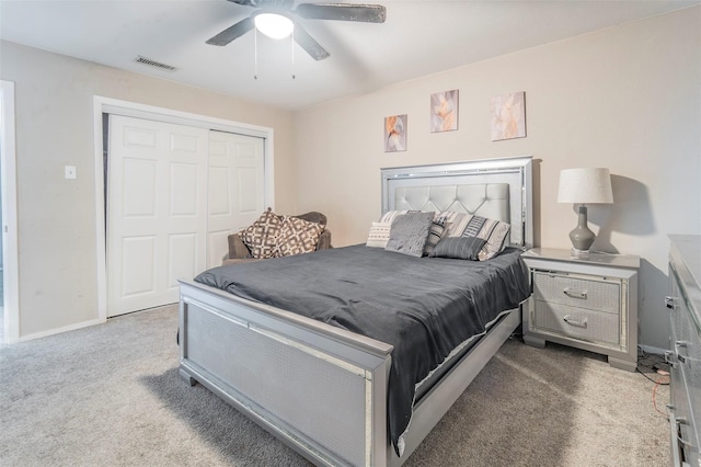 carpeted bedroom featuring a closet and ceiling fan