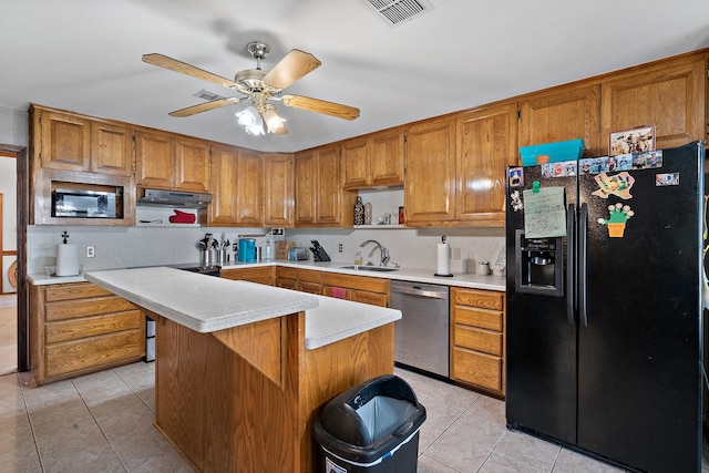 kitchen with ceiling fan, sink, a center island, black fridge, and stainless steel dishwasher