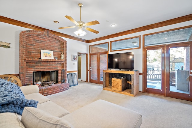 carpeted living room with crown molding, ceiling fan, and a brick fireplace