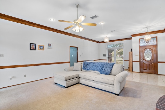 living room featuring light tile patterned floors, ceiling fan, and crown molding