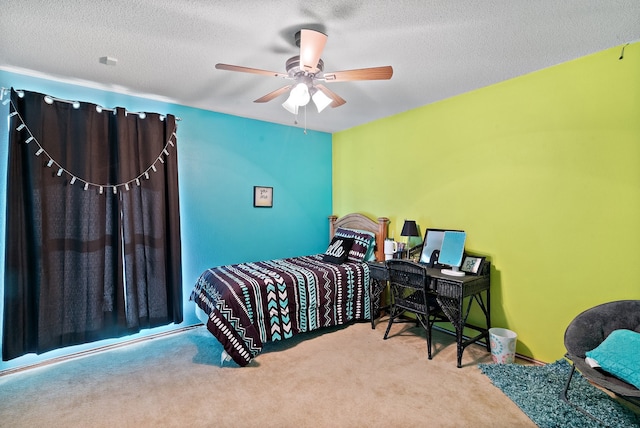 carpeted bedroom with a textured ceiling and ceiling fan